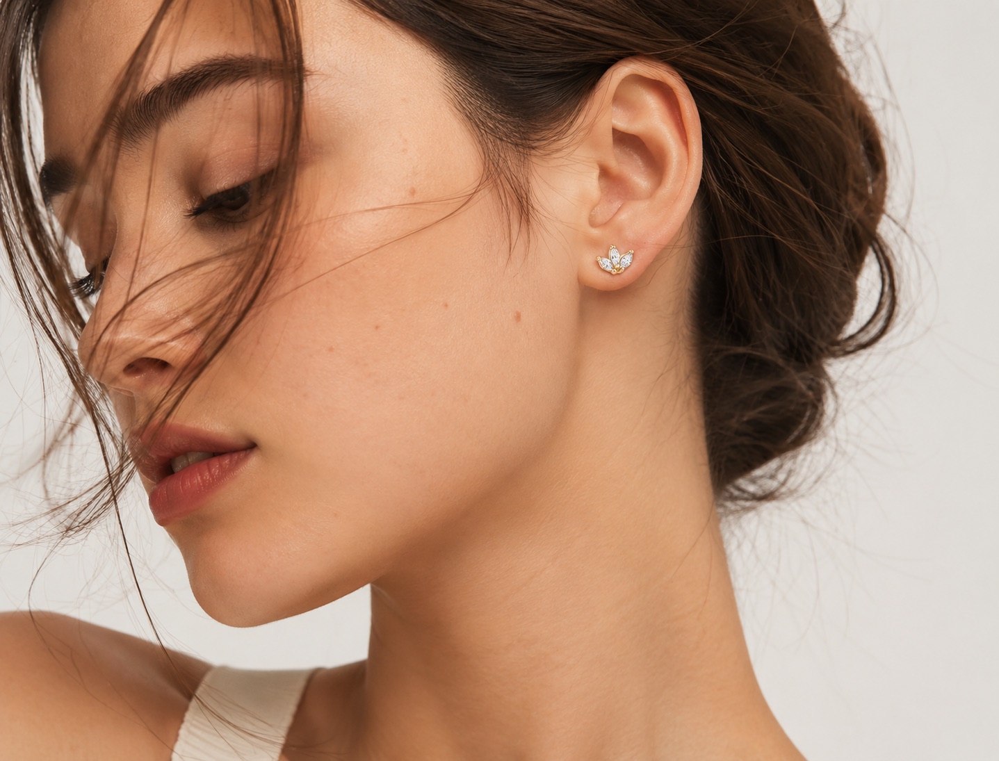 Meirā lotus pendant worn on the ear — marquise stones in 14k gold